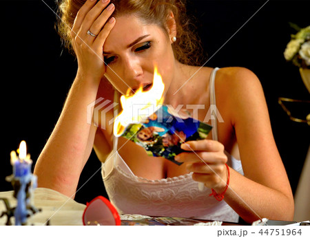 Burning photography wedding bride sitting table. Quarrel honeymoon. Wedding memories. 44751964