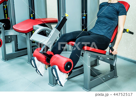 Young woman does leg exercises in gym Young woman does leg exercises in gym 44752517