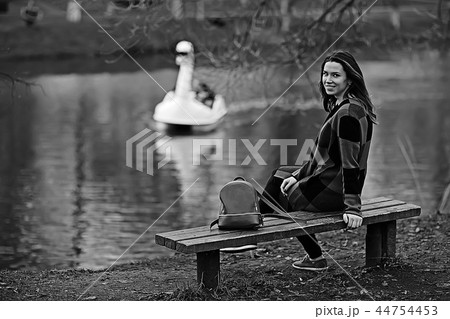 autumn sad girl outdoor / autumn weather, portrait of a young adult girl in a coat in a cage, Scottish style autumn sad girl outdoor / autumn weather, portrait of a young adult girl in a coat in a cage, Scottish style 44754453