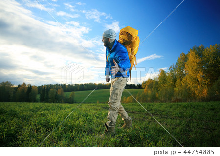 man with backpack, tourist, brutal journey, hike, the concept of active male recreation, portrait of a severe, brutal man, guy preparing equipment for the mountains 44754885