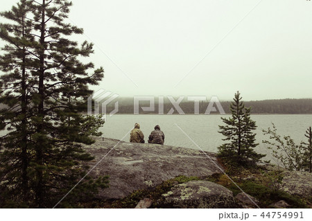man resting on the shore of a lake, cliff, meditation, concept of relaxation relaxing loneliness man resting on the shore of a lake, cliff, meditation, concept of relaxation relaxing loneliness 44754991