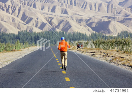 lonely man travels along deserted canyon, desert, lifeless terrain, landscape of highlands lonely man travels along deserted canyon, desert, lifeless terrain, landscape of highlands 44754992