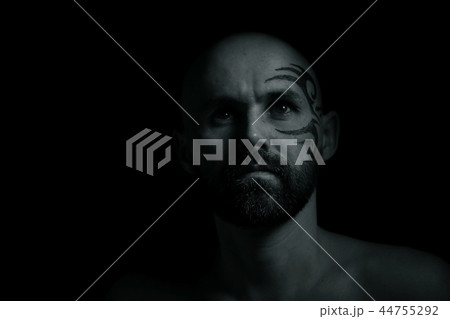 tattoo on the face, man with a tattoo, brutal bearded guy, studio portrait of a man 44755292