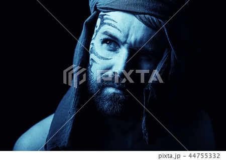 tattoo on the face, male portrait in the form of an assassin, cosplay, tattooed brutal man, guy with a tattooed face 44755332