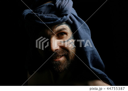 tattoo on the face, male portrait in the form of an assassin, cosplay, tattooed brutal man, guy with a tattooed face 44755387