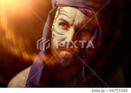 tattoo on the face, male portrait in the form of an assassin, cosplay, tattooed brutal man, guy with a tattooed face 44755393