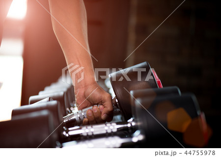 Close up muscular arm. Man hand holding dumbbell Close up muscular arm. Man hand holding dumbbell 44755978