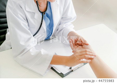 Woman Doctor and Female Patient in Hospital Office Woman Doctor and Female Patient in Hospital Office 44755983