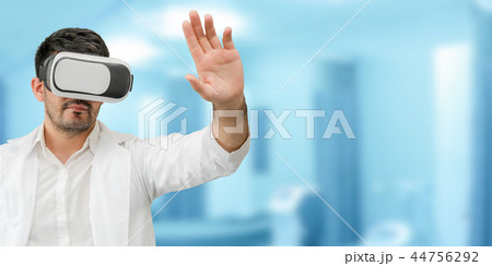 Doctor wearing VR virtual reality goggles. Doctor wearing VR virtual reality goggles. 44756292