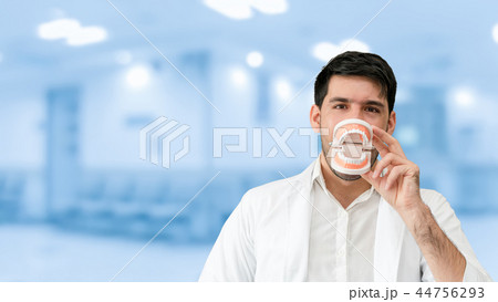 Young male dentist working in dental clinic. 44756293