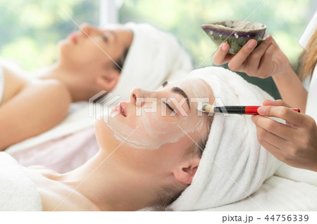 Beautiful woman having a facial treatment at spa. Beautiful woman having a facial treatment at spa. 44756339