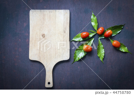 Fresh tomatoes with cutting board 44758780