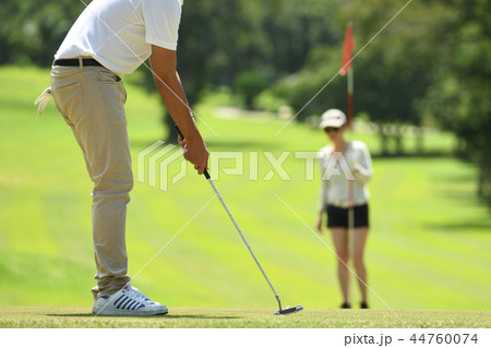 Man and woman playing golf  44760074
