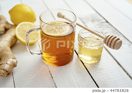 delicious hot tea with lemon on an old wooden table with ginger and honey 44763826