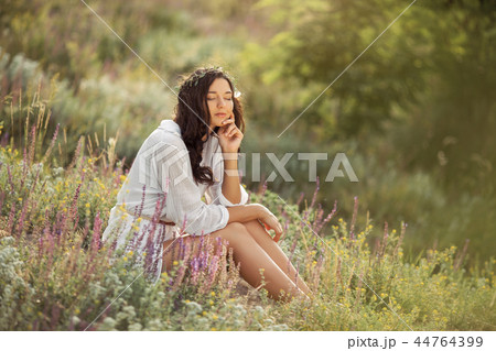 Beautiful carefree woman in fields being happy outdoors 44764399