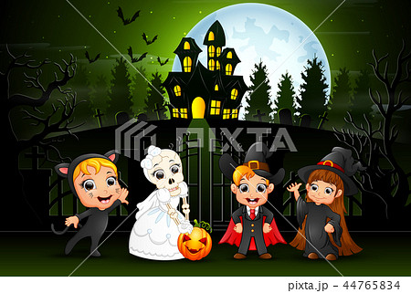 Happy halloween kids outdoors with haunted house b 44765834