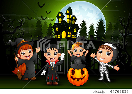 Happy halloween kids outdoors with haunted house b 44765835