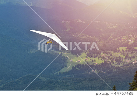 Paraglider taking off in front of mountain scenery Paraglider taking off in front of mountain scenery 44767439