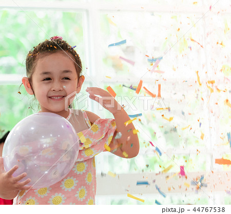 girl playing and throwing paper in kid party 44767538