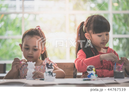 girl and boys is painting on dolls in Art group 44767539