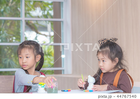 girl and boys is painting on dolls in Art group 44767540