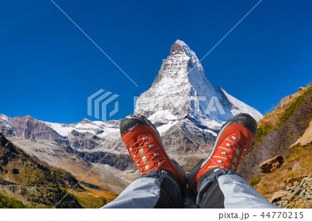 Matterhorn peak with hiking boots in Swiss Alps. Matterhorn peak with hiking boots in Swiss Alps. 44770215