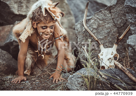 Caveman, manly boy hunting outdoors. Ancient warrior portrait. Caveman, manly boy hunting outdoors. Ancient warrior portrait. 44770939
