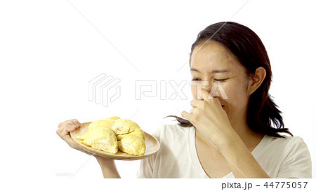 Asian girl smelling stinky durian. Smelly fruit 44775057