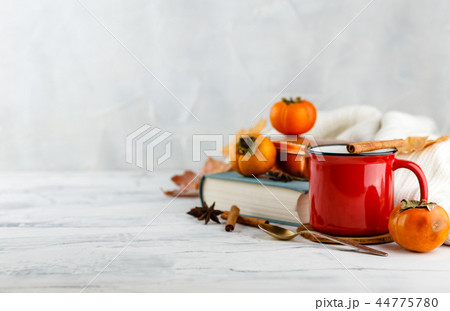 Autumn light still life with coffee and book 44775780