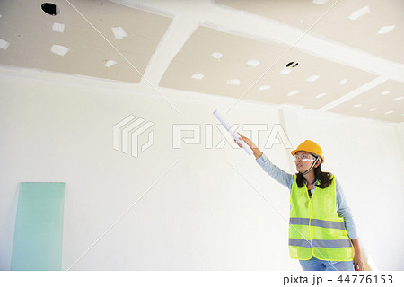 Woman engineers working in side building planning 44776153