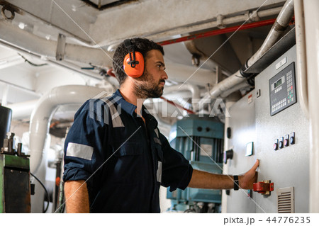 Marine engineer officer working in engine room Marine engineer officer working in engine room 44776235