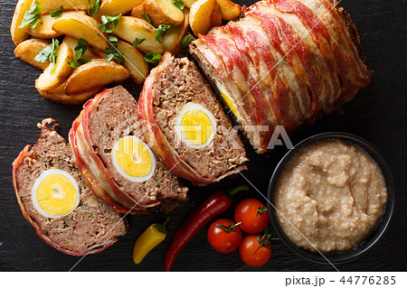Hackbraten Meat loaf with egg served with potato Hackbraten Meat loaf with egg served with potato 44776285