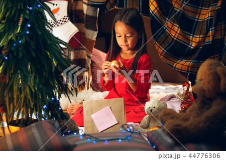 Merry Christmas and Happy Holidays. Cute little child girl writes the letter to Santa Claus near Merry Christmas and Happy Holidays. Cute little child girl writes the letter to Santa Claus near 44776306