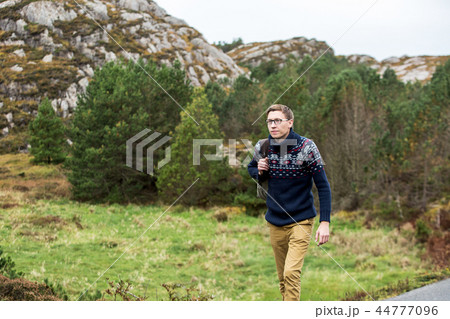 Traveler walking along the road.  44777096