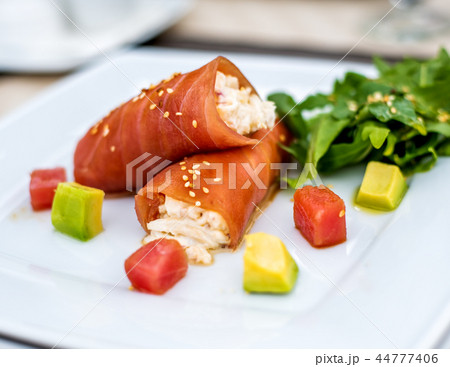 rolls of tuna with crab meat on the plate 44777406