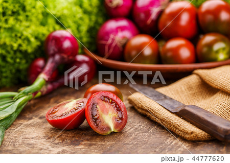 Breakfast for a vegetarian. Composition with fresh tomatoes, purple onions, lettuce, parsley and Breakfast for a vegetarian. Composition with fresh tomatoes, purple onions, lettuce, parsley and 44777620