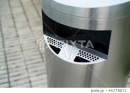Modern metallic trash bin outdoors with section for sigarettes Modern metallic trash bin outdoors with section for sigarettes 44778671