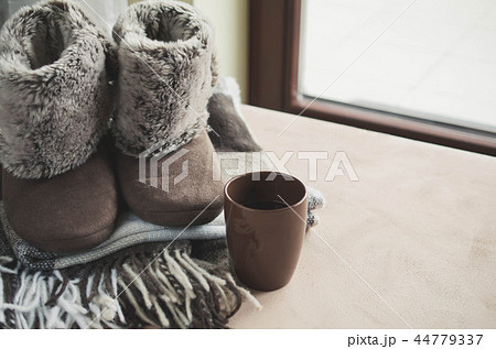 Warm home clothes. Woolen plaid and home slippers 44779337