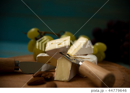 cheese camembert with raspberries and grapes on table cheese camembert with raspberries and grapes on table 44779646
