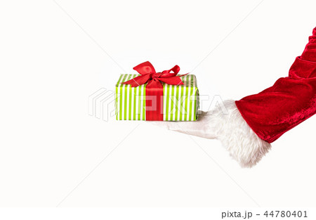Santas hand holding a giftbox with red bow Santas hand holding a giftbox with red bow 44780401