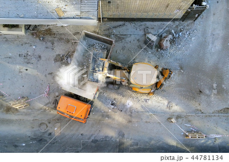 Bulldozer loader uploading waste and debris into dump truck at construction site. building Bulldozer loader uploading waste and debris into dump truck at construction site. building 44781134