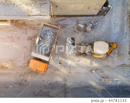 Bulldozer loader uploading waste and debris into dump truck at construction site. building Bulldozer loader uploading waste and debris into dump truck at construction site. building 44781135