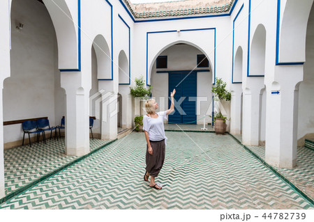 Woman admiring traditional moroccan architecture in one of the palaces in medina of Marrakesh Woman admiring traditional moroccan architecture in one of the palaces in medina of Marrakesh 44782739