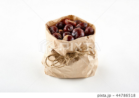 Chestnuts in paper bag on white background 44786518