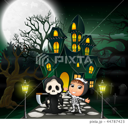 Happy halloween costume kid in front of the haunte Happy halloween costume kid in front of the haunte 44787423