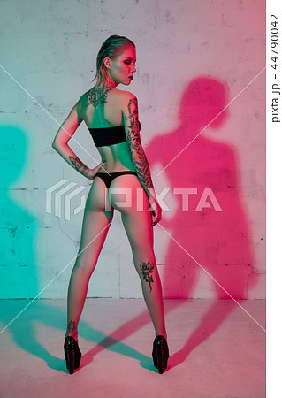 Tattooed girl in lingerie rearview 44790042