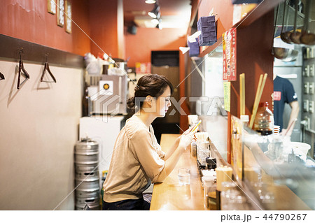 一人でラーメンを楽しむ女性 44790267