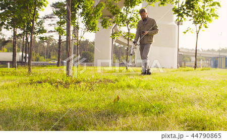 Ecologist measuring the level of radiation near highway 44790865