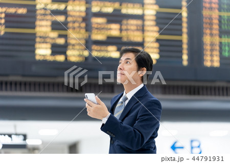 空港の電光掲示板の前で確認するビジネスマン　国際空港　仕事 44791931