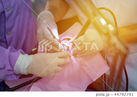 doctor cleaning teeth patient with ultrasonic tool doctor cleaning teeth patient with ultrasonic tool 44792791
